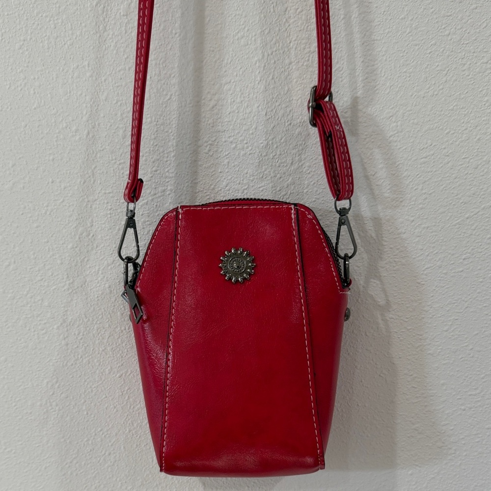 Red Leather Crossbody Bag with Decorative Medallion